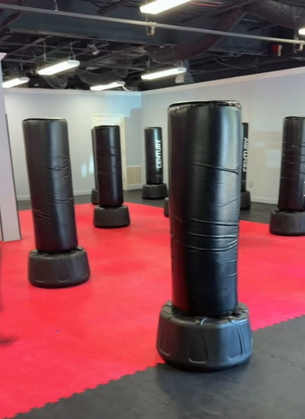 An instructor supervising Hit The Bag. students closely during class at Waverly Martial Arts in Patchogue